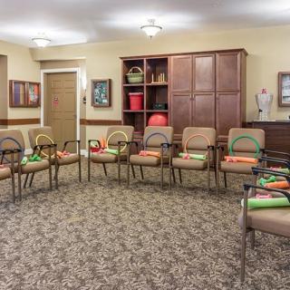 A well-organized meeting room with chairs arranged in a circle.