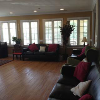 A spacious living room with large windows and comfortable seating.