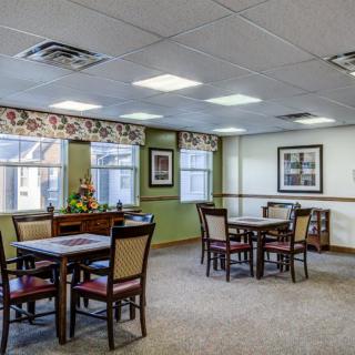 A cozy dining area with tables and chairs, featuring decorative elements and ambient lighting.
