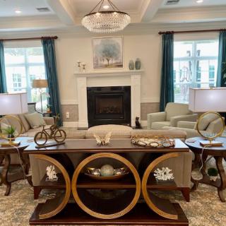 A well-decorated living room with comfortable seating and elegant furnishings.