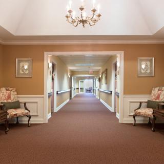 A well-lit hallway with elegant decor and comfortable seating.
