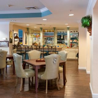 A cozy dining area with neatly arranged tables and chairs, offering a warm and inviting atmosphere.