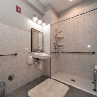 An accessible bathroom with a walk-in shower and grab bars.