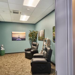 A cozy waiting room with comfortable chairs and soothing decor.