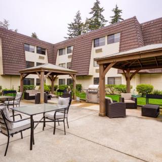 A residential courtyard with outdoor seating and gazebos.