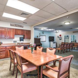 A spacious kitchen and dining area with wooden furniture and cabinetry.