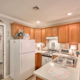 A cozy kitchen with wooden cabinets and modern appliances.
