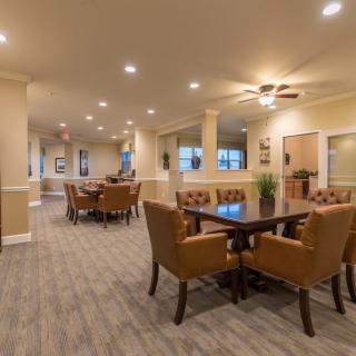 A spacious dining area with comfortable seating and warm lighting.