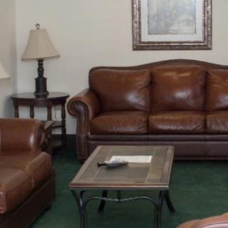 A cozy living room with a leather sofa set and a coffee table.