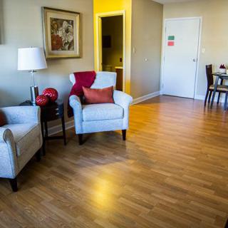 A cozy living room with comfortable chairs and wooden flooring.