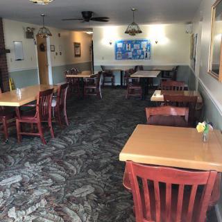 An empty restaurant interior with arranged tables and chairs.