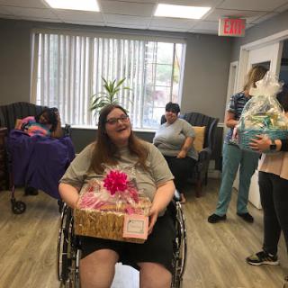 A joyful moment during a community celebration, with a participant receiving gifts.