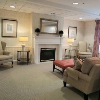 A cozy living room with comfortable seating around a fireplace.