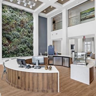 A modern office reception area featuring a vertical plant wall and sleek design elements.