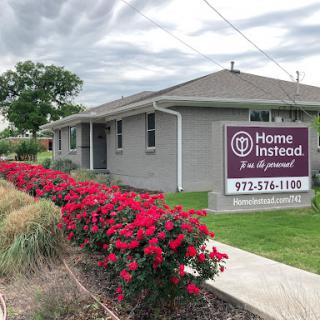 A home care service office with vibrant landscaping and signage.