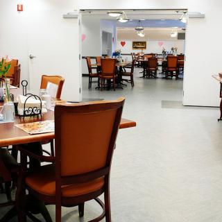 An empty dining area with neatly arranged tables and chairs.