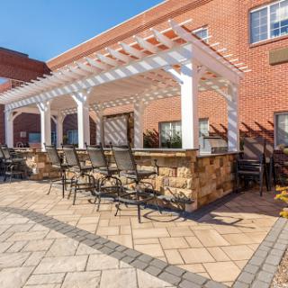 A cozy outdoor seating area featuring a pergola and comfortable furniture, perfect for relaxation.