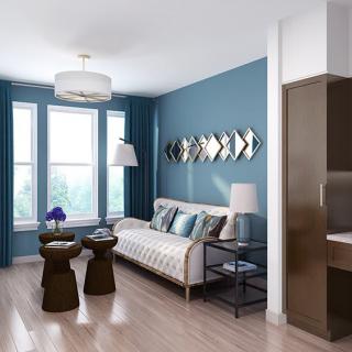 A modern living room with blue walls, stylish furniture, and natural light.