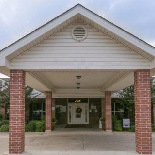 Entrance to a building with brick columns and a covered porch.