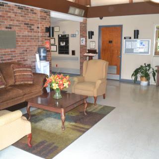 A cozy and inviting lobby area featuring a sofa, chairs, and a decorative coffee table.