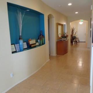 A modern hallway with decorative elements and a built-in shelf display.