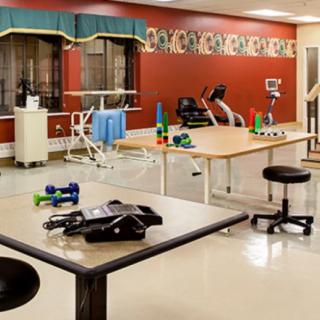 A physical therapy and rehabilitation room equipped with various exercise devices.