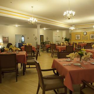 A cozy restaurant dining area with neatly arranged tables and warm lighting.