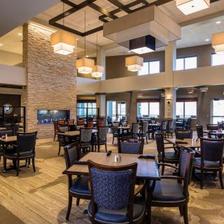 Modern restaurant interior with elegant lighting and neatly arranged tables.