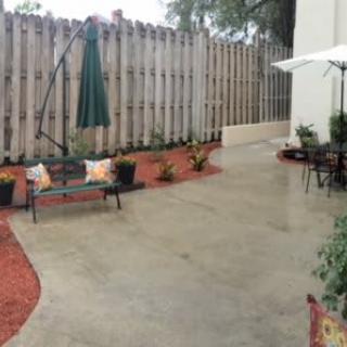 A cozy patio area with garden plants and seating arrangements.