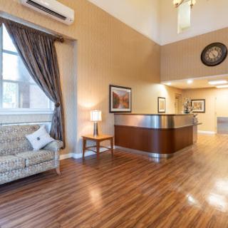 A welcoming lobby area featuring a reception desk, comfortable seating, and elegant decor.