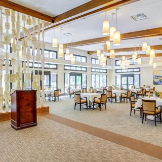 Spacious and elegantly designed dining area with modern lighting and furnishings.