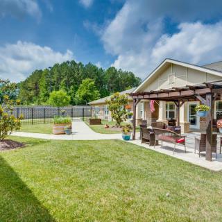 A beautiful backyard with a pergola and well-maintained lawn, perfect for outdoor relaxation.