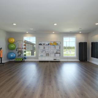 A bright and spacious exercise room equipped with yoga balls and mirrors.