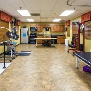 A spacious gym room equipped with various exercise machines and equipment for workouts.