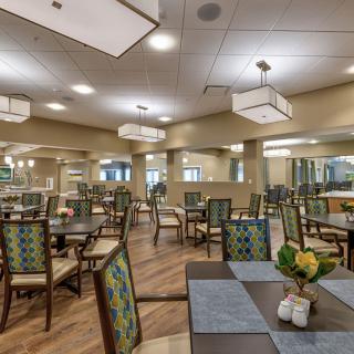 A spacious dining room featuring modern decor and well-arranged tables and chairs.