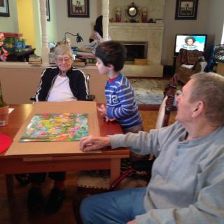A family enjoying a board game together in the living room.