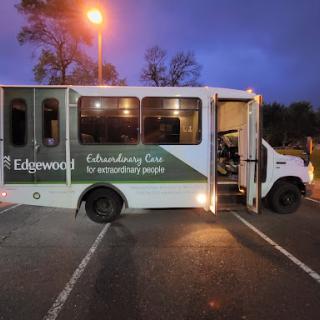 An Edgwood community service bus parked in an evening setting.
