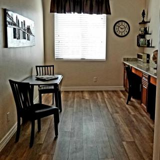 A cozy kitchen nook with a small dining table and chairs, featuring a window that lets in natural light.