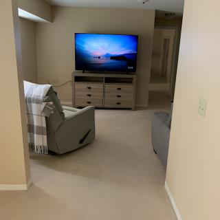 Cozy living room with a TV and armchair.