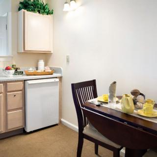 A cozy kitchen and dining area with a table set for a meal.
