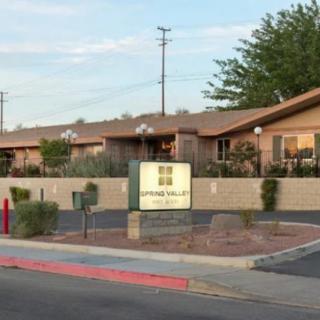 A residential complex with a central sign and desert-climate landscaping.
