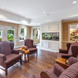 A cozy living room with comfortable seating and an aquarium centerpiece.