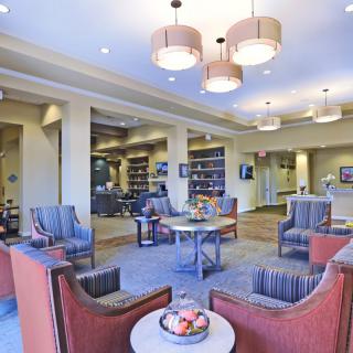 A modern lobby seating area with comfortable chairs and stylish lighting.