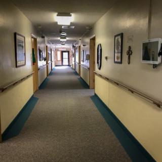 A long hallway with illuminated lights and decorated walls in a building.