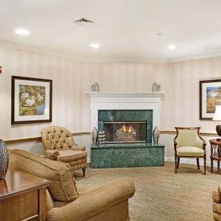 A cozy living room with a fireplace and comfortable seating.
