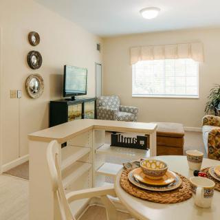 A cozy living room with a TV and dining area.