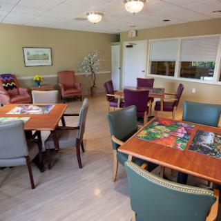 A cozy lounge area featuring tables and chairs, ideal for socializing and activities.