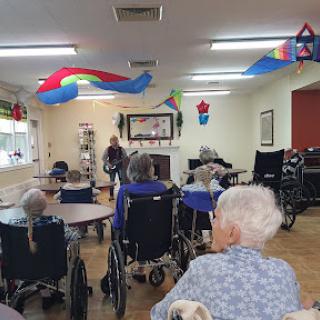 Residents enjoying a communal activity in a decorated nursing home.