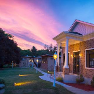 A beautifully illuminated building beneath a vibrant sunset sky.
