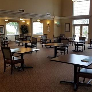 An empty dining room with neatly arranged tables and chairs.